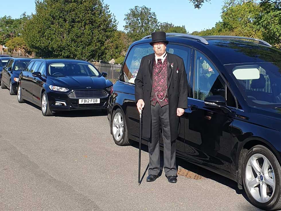 Funeral director and hearse